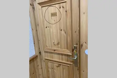 a wooden door with a circle on it at Le Mallory in Chamonix-Mont-Blanc