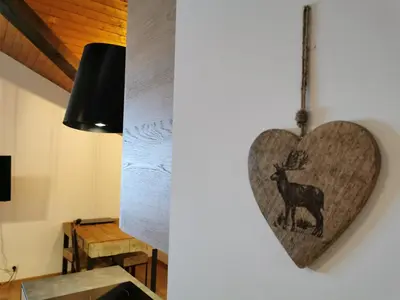 a heart shaped plaque hanging on a wall at Le Mallory in Chamonix-Mont-Blanc