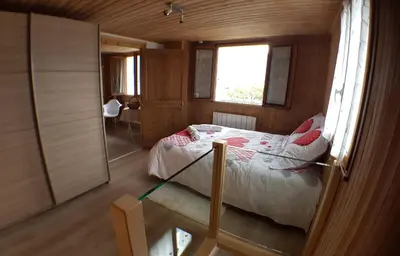 a small bedroom with a bed and a window at Chalet avec terrasse et vue sur le Mt-Blanc in Sallanches