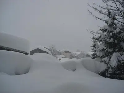 a snow covered yard with a tree and a house at Prachtig familie appartement voor 6 personen in het hart van Argentière, Chamonix Mont-Blanc in Chamonix-Mont-Blanc