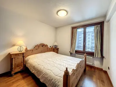 a bedroom with a large bed and a window at Appartement cosy au centre de Chamonix avec parking - FR-1-507-42 in Chamonix-Mont-Blanc
