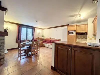 a kitchen and living room with a table and chairs at Appartement cosy au centre de Chamonix avec parking - FR-1-507-42 in Chamonix-Mont-Blanc