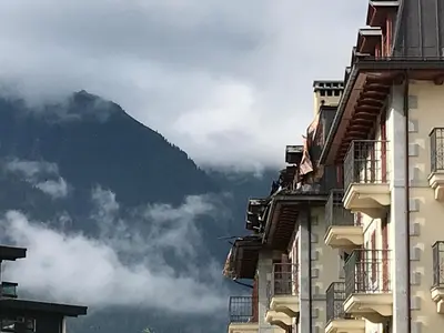a view of a mountain from between two buildings at Appartement cosy au centre de Chamonix avec parking - FR-1-507-42 in Chamonix-Mont-Blanc