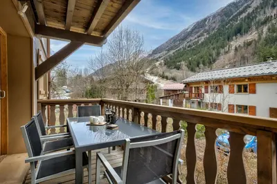 a table and chairs on a balcony with a view at Residence la Blaitiere in Chamonix-Mont-Blanc