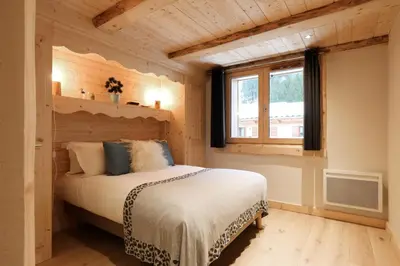 a bedroom with a bed in a room with a window at Residence la Blaitiere in Chamonix-Mont-Blanc