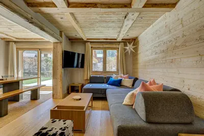 a living room with two couches and a tv at Residence la Blaitiere in Chamonix-Mont-Blanc