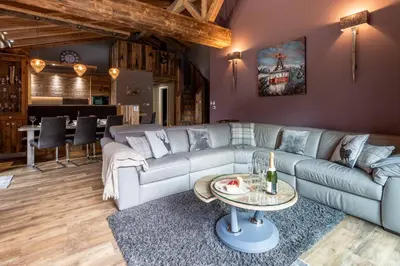 a living room with a couch and a table at Chalet des Amis appt 2 - Chamonix All Year in Chamonix-Mont-Blanc