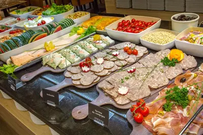 a buffet filled with different types of food on a table at SOWELL HOTELS Mont Blanc et SPA in Saint-Gervais-les-Bains