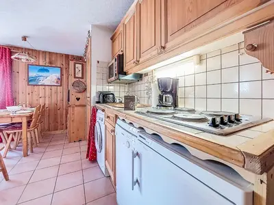 a kitchen with a washing machine and a microwave at Apartment Jardins Alpins by Interhome in Saint-Gervais-les-Bains