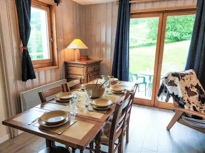 a living room with a couch and a table and a kitchen at Apartment Le Parc du Mont Joly-3 by Interhome in Saint-Gervais-les-Bains