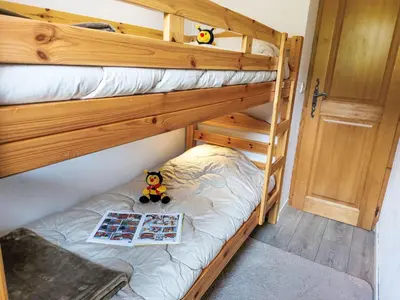 a bedroom with a bed with a towel on it at Apartment Le Parc du Mont Joly-3 by Interhome in Saint-Gervais-les-Bains