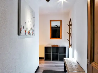 a hallway with a white wall and a mirror at Apartment L'Espace Montagne-16 by Interhome in Chamonix-Mont-Blanc
