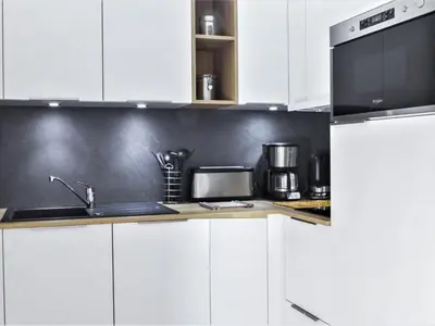 a white kitchen with a sink and a microwave at Apartment L'Espace Montagne-16 by Interhome in Chamonix-Mont-Blanc