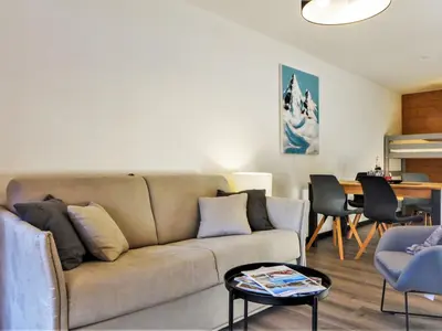 a living room with a couch and a table at Apartment L'Espace Montagne-16 by Interhome in Chamonix-Mont-Blanc