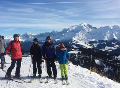 a group of people standing on top of a ski slope at Les Clochettes in Megève