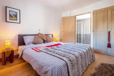 a bedroom with a large bed and a window at IRIS A3 Chalet Delys in Les Houches