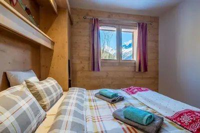 a bedroom with two beds and a window at IRIS A3 Chalet Delys in Les Houches