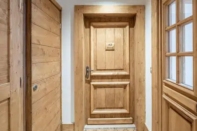 a wooden door in a room next to a window at IRIS A3 Chalet Delys in Les Houches