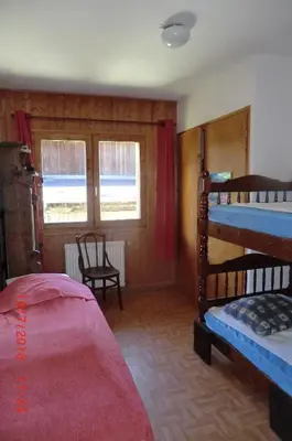 a bedroom with two bunk beds and a window at Les Passereaux 2 in Saint-Gervais-les-Bains