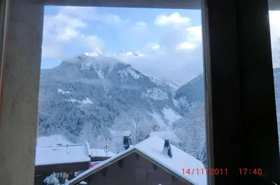 a window with a view of a snow covered mountain at Les Passereaux 2 in Saint-Gervais-les-Bains