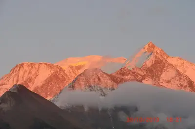 a mountain range with clouds in front of it at Les Passereaux 2 in Saint-Gervais-les-Bains