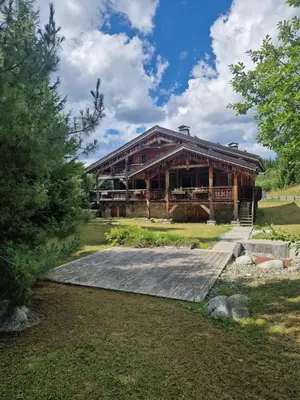 a large wooden building with a driveway in front of it at Beautiful Nirvana in Megève