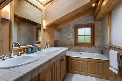 a bathroom with two sinks and a large mirror at Beautiful Nirvana in Megève