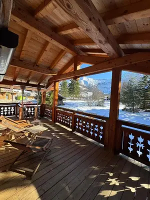 a wooden deck with a view of the mountains at Beautiful Nirvana in Megève