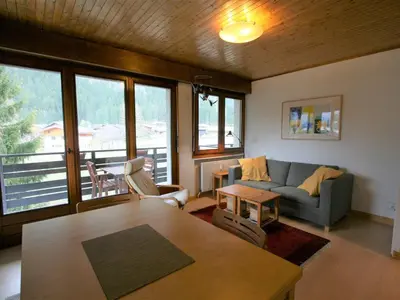 a living room with a couch and a table at Charmant T2 Chamonix avec balcon, accepte animaux - FR-1-507-45 in Chamonix-Mont-Blanc