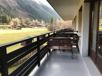 a row of benches sitting on a balcony with a view at Charmant T2 Chamonix avec balcon, accepte animaux - FR-1-507-45 in Chamonix-Mont-Blanc