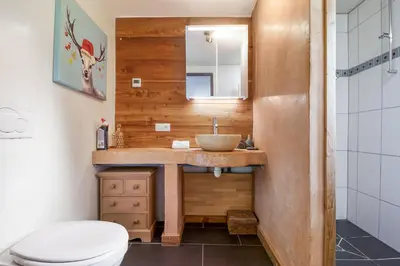 a bathroom with a sink and a shower at Chalet Taconnaz - Warm & Cosy 3BR Chalet with Fireplace in Nature - By Cozee Rentals in Les Houches
