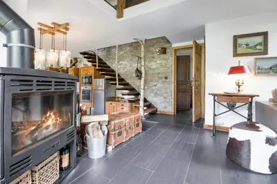 a bedroom with a large bed with wooden ceilings at Chalet Taconnaz - Warm & Cosy 3BR Chalet with Fireplace in Nature - By Cozee Rentals in Les Houches