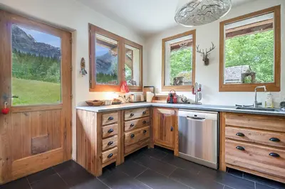 a bedroom with wooden walls and a bed and a window at Chalet Taconnaz - Warm & Cosy 3BR Chalet with Fireplace in Nature - By Cozee Rentals in Les Houches
