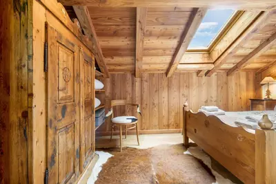a bedroom with a bed with towels on it at Chalet Taconnaz - Warm & Cosy 3BR Chalet with Fireplace in Nature - By Cozee Rentals in Les Houches