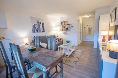 a living room with a table and a dining room at Studio rénové dans le centre piéton de Megève in Megève
