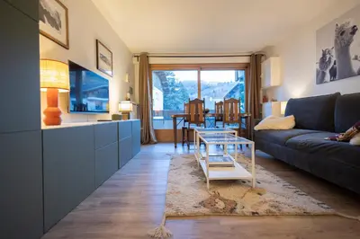 a living room with a couch and a table at Studio rénové dans le centre piéton de Megève in Megève