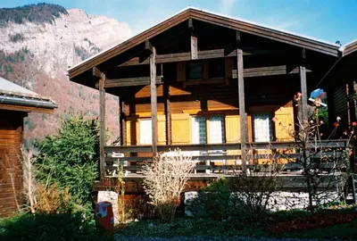 a wooden house with a mountain in the background at Chalet cosy à Sixt-Fer-à-Cheval avec vue sur la montagne in Sixt