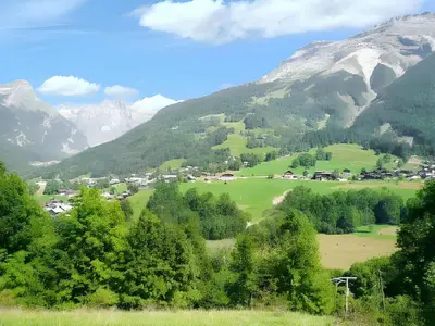 a valley in the mountains with trees and houses at Chalet cosy à Sixt-Fer-à-Cheval avec vue sur la montagne in Sixt
