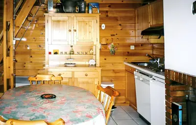 a kitchen with a table and chairs in a cabin at Chalet cosy à Sixt-Fer-à-Cheval avec vue sur la montagne in Sixt