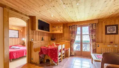 a dining room with a table and a bedroom at Appartement confortable à Megève | 46m² | Vue sur montagne in Megève