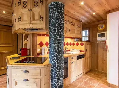 a kitchen with a tall pole in the middle of it at Appartement confortable à Megève | 46m² | Vue sur montagne in Megève