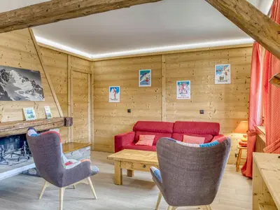 a living room with a red couch and two chairs at Appartement Megève Jaillet, 2 Chambres, Balcon, Parking - FR-1-453-226 in Megève