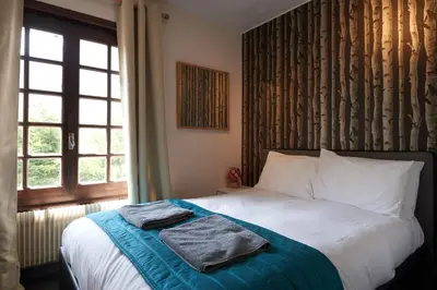 a bedroom with a bed with two towels on it at Chamonix Lodge in Chamonix-Mont-Blanc