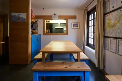 a table and bench in a train room at Chamonix Lodge in Chamonix-Mont-Blanc