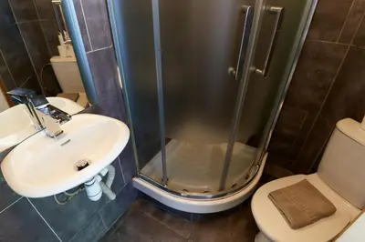 a bathroom with a shower and a sink and a toilet at Chamonix Lodge in Chamonix-Mont-Blanc