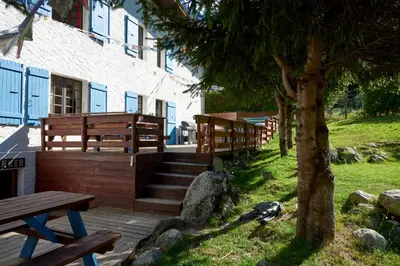 a bird sitting on a wooden deck next to a building at Chamonix Lodge in Chamonix-Mont-Blanc