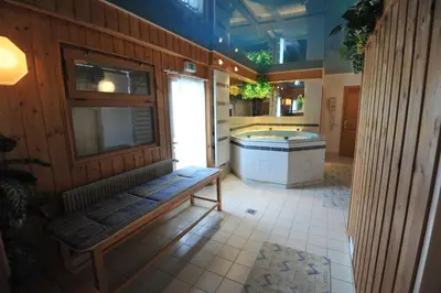 a large bathroom with a bench and a tub at Hotel Le Christiania in Les Contamines-Montjoie