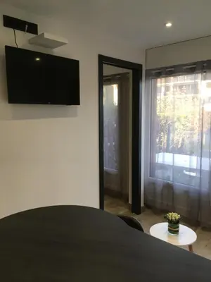 a room with a flat screen tv on a wall at MONT BLANC HOLIDAYS dans résidence avec Gardien in Sallanches