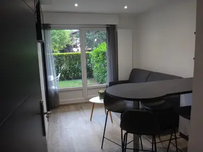 a dining room with a table and chairs and a window at MONT BLANC HOLIDAYS dans résidence avec Gardien in Sallanches
