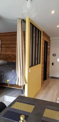a room with a bed and a yellow door at Elégant et moderne, au pied du Mont-Blanc in Saint-Gervais-les-Bains